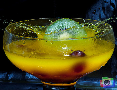 Half a KIWI Fruit Dropped into coloured water (with Glacier Cherries)